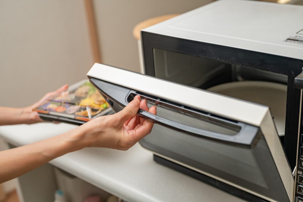 電子レンジに弁当を入れる様子