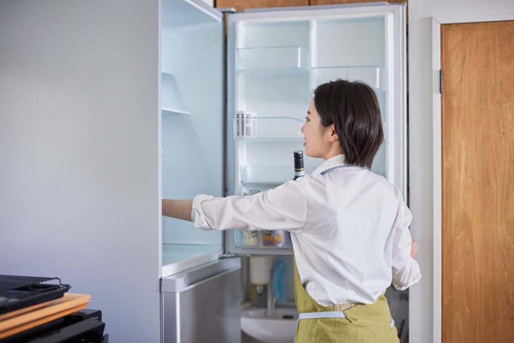 冷蔵庫を開ける女性